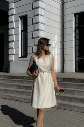 a lady in a white dress with a belt